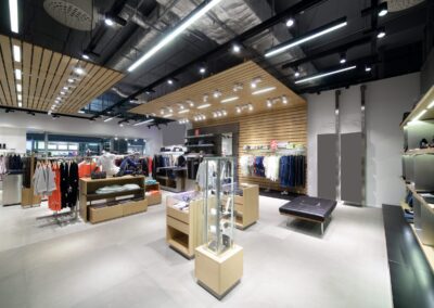 The interior of a clothing store with a wooden ceiling.