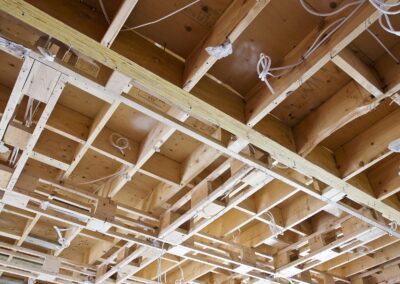 A room with a wooden ceiling and wires.