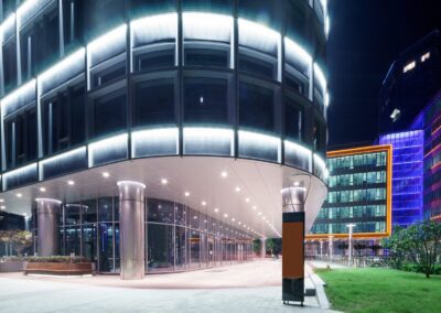 A modern office building lit up at night.