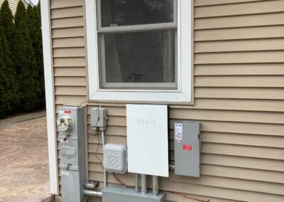 A home with an electric panel on the side of the house.