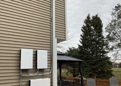 A solar panel on the side of a house.